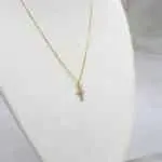 Conjunto de cadena y colgante cruz en oro 18k, diseño femenino y luminoso.